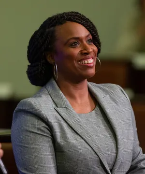 Congresswoman Ayanna Pressley Smiling In Gray Pantsuit Wallpaper