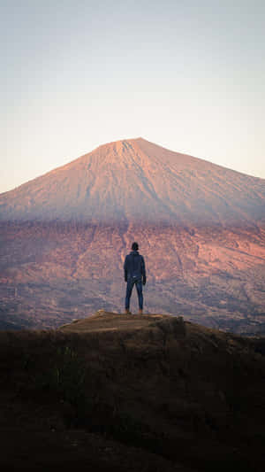 Contemplating_ Mountain_ Peak_ Sunset Wallpaper