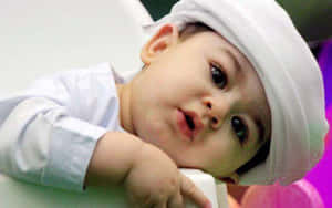 Contemplative Babyin White Hat Wallpaper