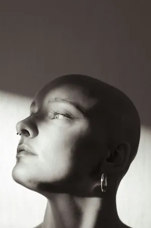 Contemplative Bald Woman Portrait Wallpaper