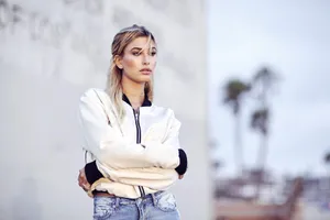 Contemplative Blonde Woman Outdoors Wallpaper