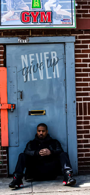 Contemplative Boxer Outside Gym Wallpaper