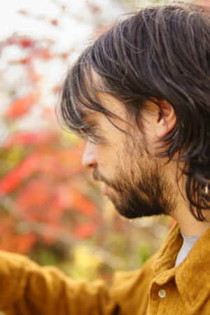 Contemplative Man Autumn Backdrop Wallpaper