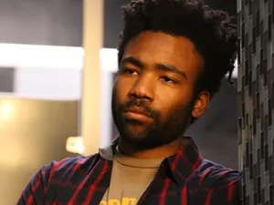 Contemplative Man Indoor Setting Wallpaper