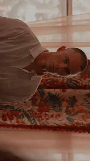 Contemplative Man Leaning Indoors Wallpaper