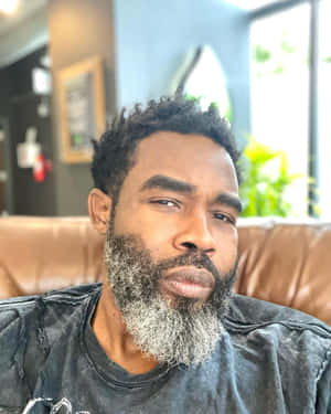 Contemplative Man Leather Couch Wallpaper