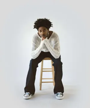 Contemplative_ Man_on_ Stool Wallpaper