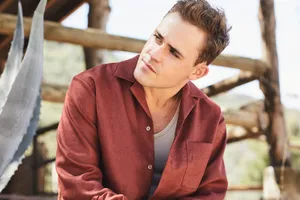 Contemplative Man Outdoors Wallpaper