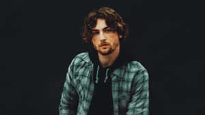 Contemplative Manin Plaid Shirt Wallpaper