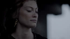 Contemplative Woman Dark Backdrop Wallpaper