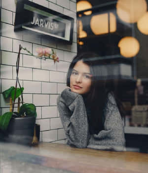 Contemplative Womanat Cafe Wallpaper