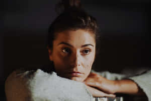 Contemplative Womanin Dim Light Wallpaper