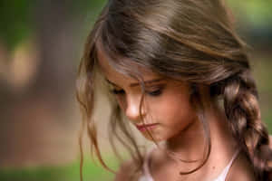 Contemplative Young Girl Outdoors.jpg Wallpaper