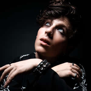 Contemplative Young Man Dark Background Wallpaper