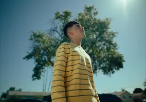 Contemplative Young Manin Striped Sweater Wallpaper