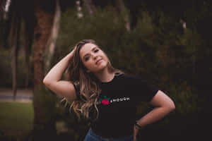 Contemplative Young Woman Outdoors Wallpaper