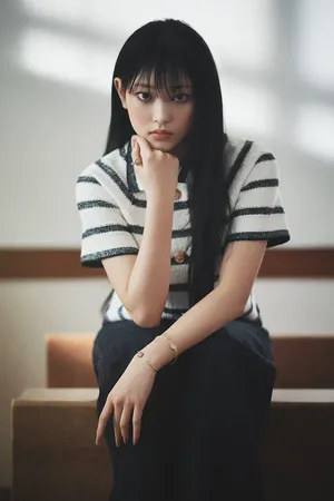 Contemplative Young Woman Sitting Wallpaper