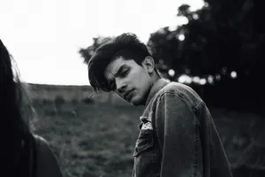 Contemplative Youthin Field Wallpaper