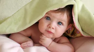 Cool Cute Baby Under Mattress Wallpaper