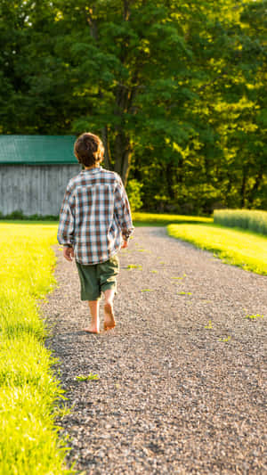 Country Boy Walkingon Rural Path Wallpaper