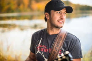 Country Music Superstar Luke Bryan Strums His Guitar Onstage Wallpaper