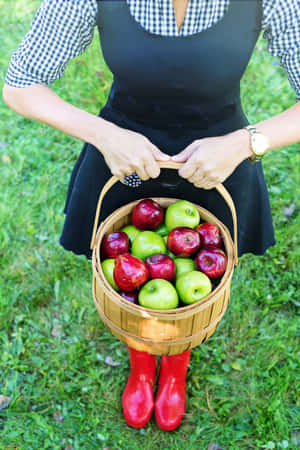 Couple Enjoying An Apple-picking Adventure Wallpaper