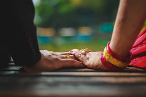 Couple Holding Hands On Bench Wallpaper