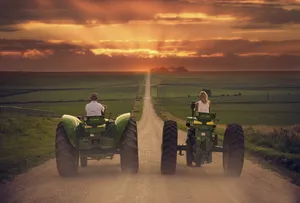 Couple Riding John Deere Tractors Wallpaper