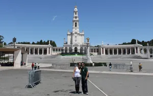 Couple Taking Photo At Fatima Sanctuary Wallpaper