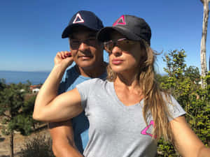 Couplein Matching Hats Outdoors Wallpaper