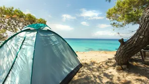 Cozy Beach Camping Under The Starlit Sky Wallpaper