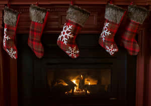 Cozy Christmas Fireplace With Stockings Wallpaper