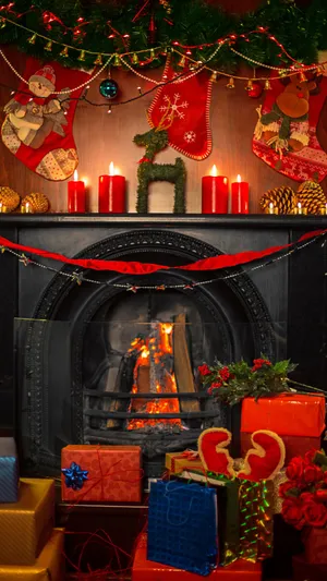 Cozy Christmas Fireplacewith Giftsand Decorations Wallpaper