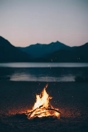 Cozy Fall Bonfire And Friends Gathering Wallpaper