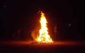 Cozy Fall Bonfire Under A Starlit Sky Wallpaper