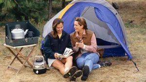 Cozy Fall Camping Under A Canopy Of Vibrant Autumn Foliage Wallpaper