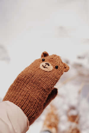 Cozy Pair Of Mittens On Wooden Background Wallpaper