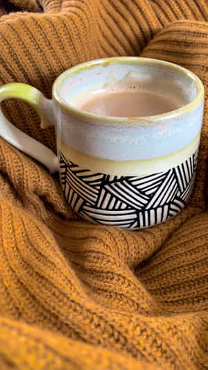 Cozy Winter Mug Wrappedin Knitwear Wallpaper