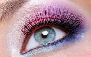 Create A Sultry And Alluring Gaze With A Subtle Pop Of Purple Eye Shadow Wallpaper