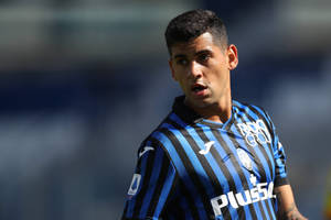 Cristian Romero In Blue And Black Wallpaper