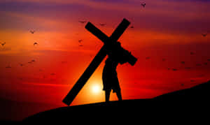 Cross Bearing Silhouetteat Sunset Wallpaper