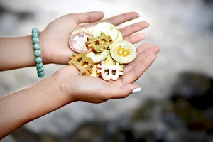 Cryptocurrency Coins On Hand Wallpaper