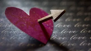 Cupid Arrow Piercing Heart Wallpaper