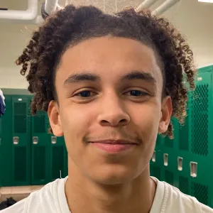 Curly Haired Boy Smiling Wallpaper