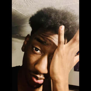 Curly Haired Boy Thoughtful Pose Wallpaper