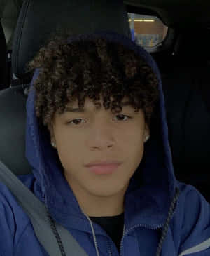 Curly Haired Boyin Blue Hoodie Wallpaper