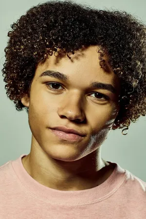 Curly Haired Boyin Pink Shirt Wallpaper