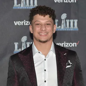 Curly Haired Boyin Suitat Event Wallpaper