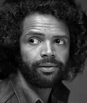 Curly Haired Man Portrait Wallpaper