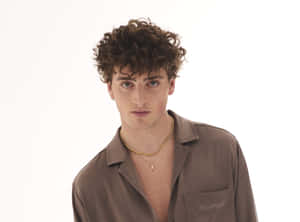 Curly Haired Manin Brown Shirt Wallpaper